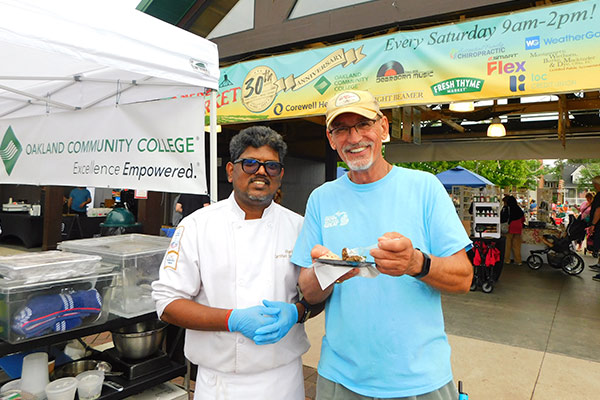 OCC Chef and patron enjoying food at the Farmers Market