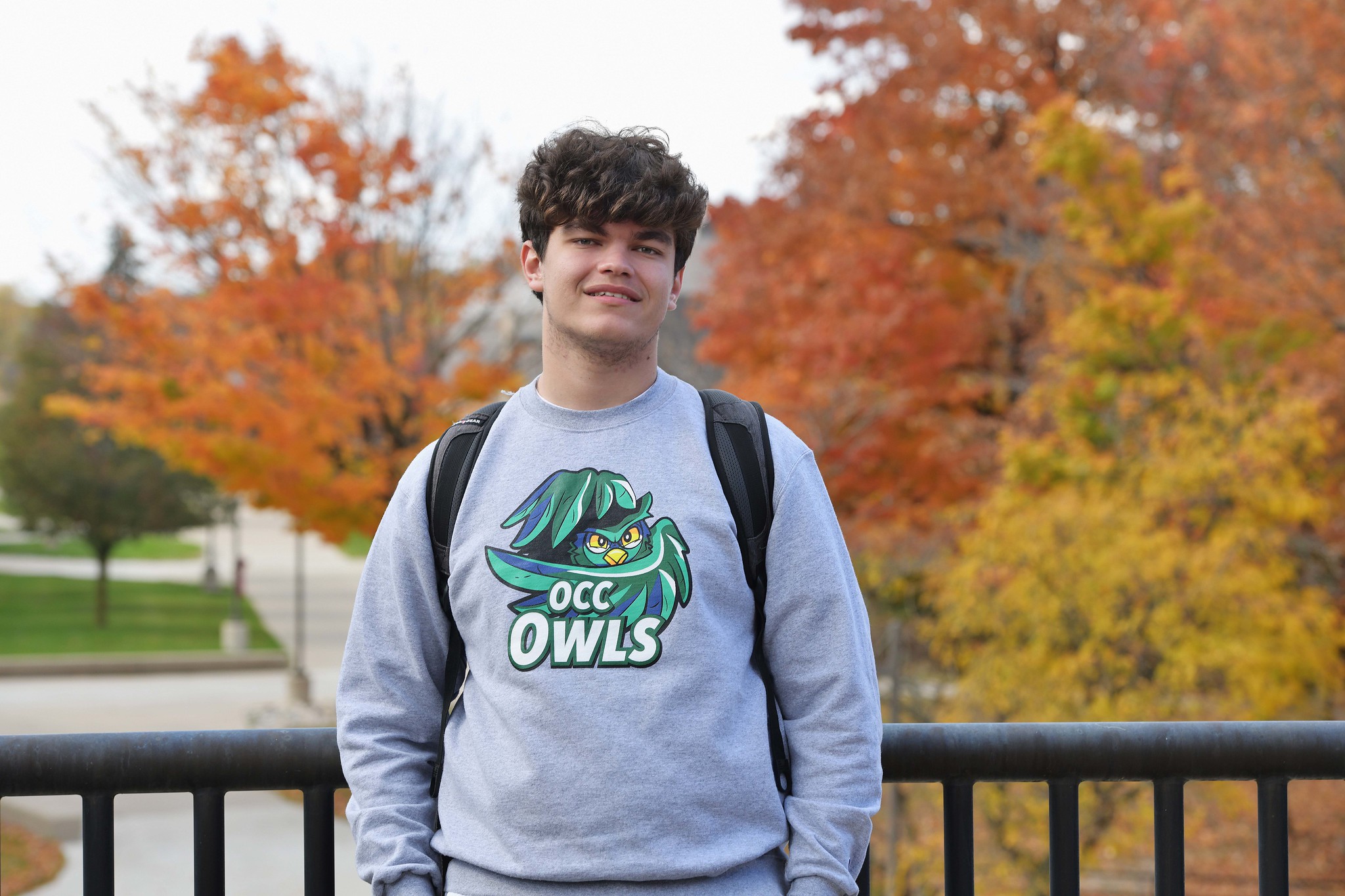 Student wearing OCC Owls sweatshirt