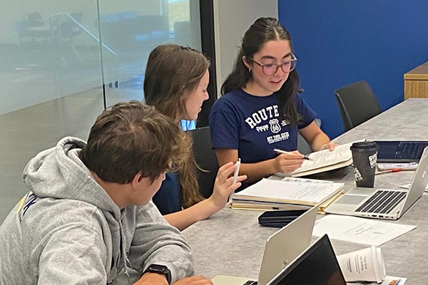 Student government students working together at a table